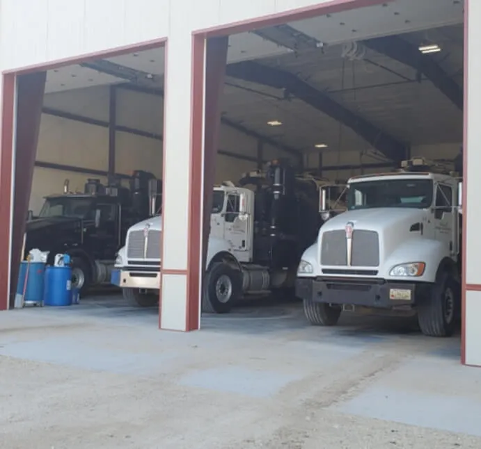 two Valley Hydro Excavation trucks in a garage